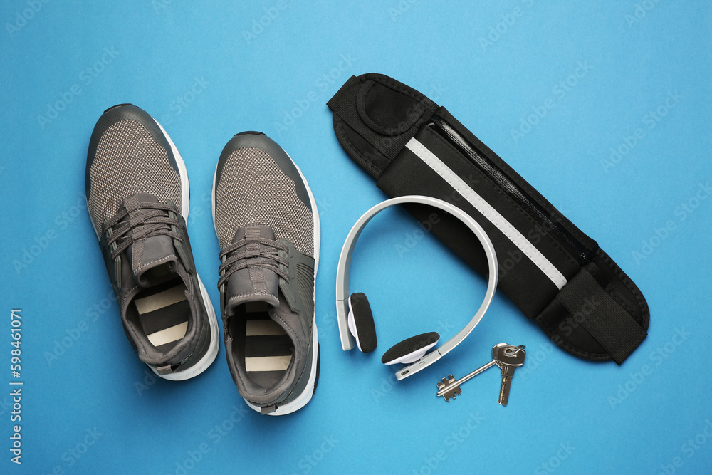 Flat lay composition with stylish black waist bag on light blue background Flat lay composition with stylish black waist bag on light blue background