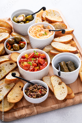 Snack board with toasted baguette and variety of dips