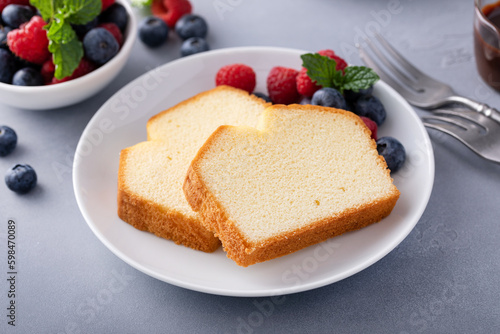 Classic pound cake sliced served with fresh berries