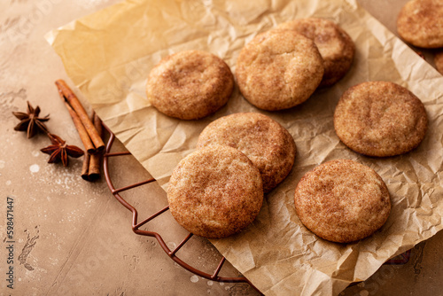 Cinnamon cookies on a parchment paper with milk photo