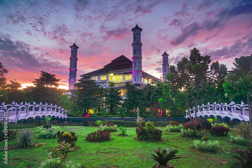 Beautiful mosque with a bridge over the pond. Sunrise at the Tajug Gede Mosque, Cilodong, Purwakarta. photo