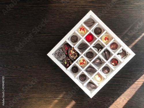 A box of handmade chocolates of different colors