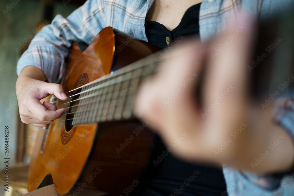 Fototapeta premium Happy young Woman hands playing acoustic guitar musician &nbsp;alone compose instrumental song&nbsp;lesson on playing the guitar