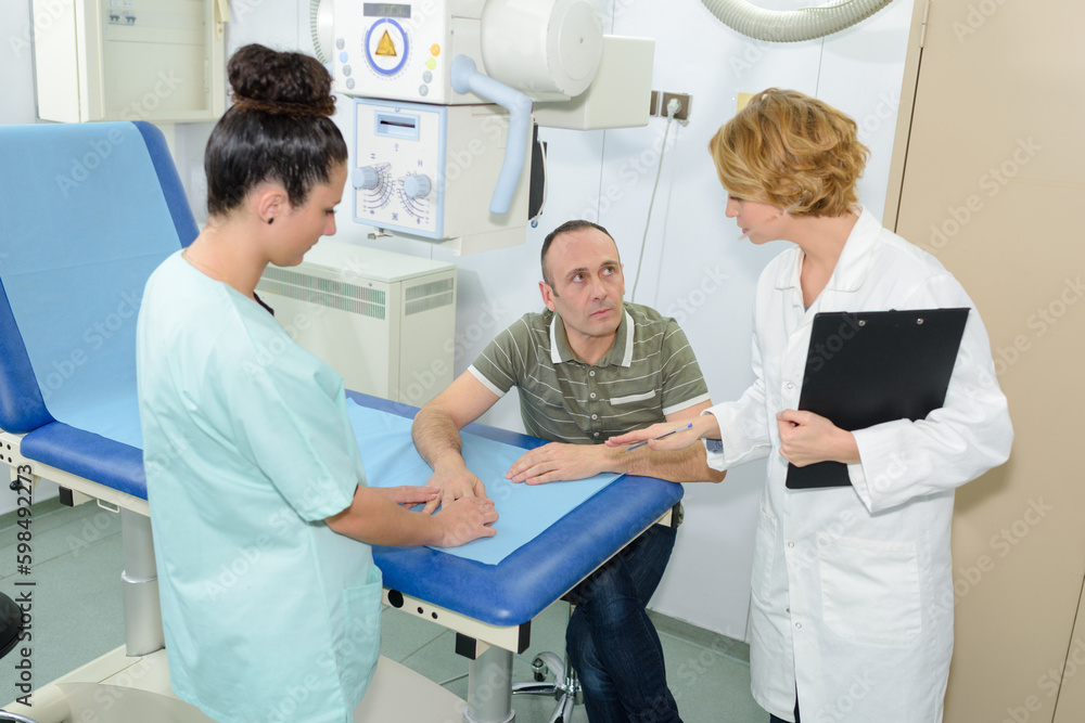 a nurse examining patients hand a nurse examining patients hand