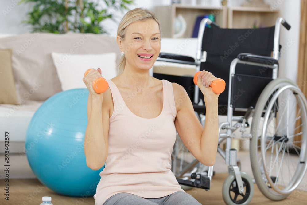 happy mature woman exercising with dumbbells happy mature woman exercising with dumbbells