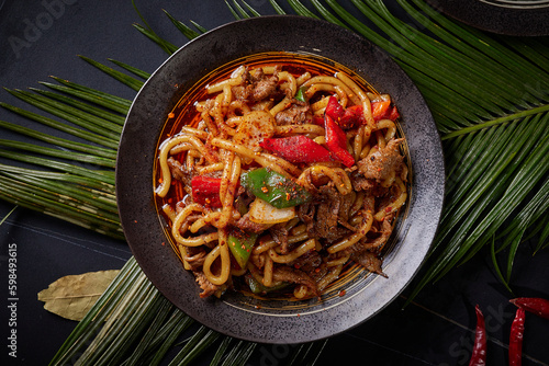 Spicy Beef Rice Noodles,BBQ food, indoor shot, dark tabletop background