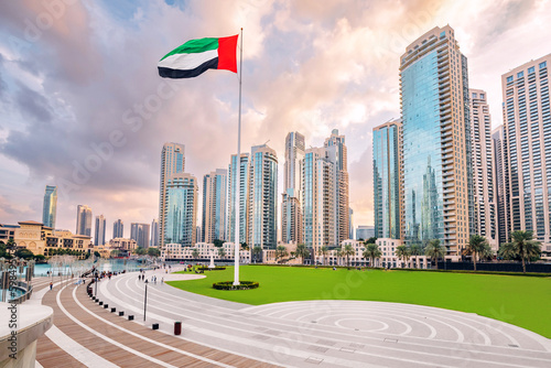 Obraz na płótnie Scenic view of Dubai skyline, with the skyscraper buildings and national flag. Sightseeing and travel destinations in Arab Emirates w salonie
