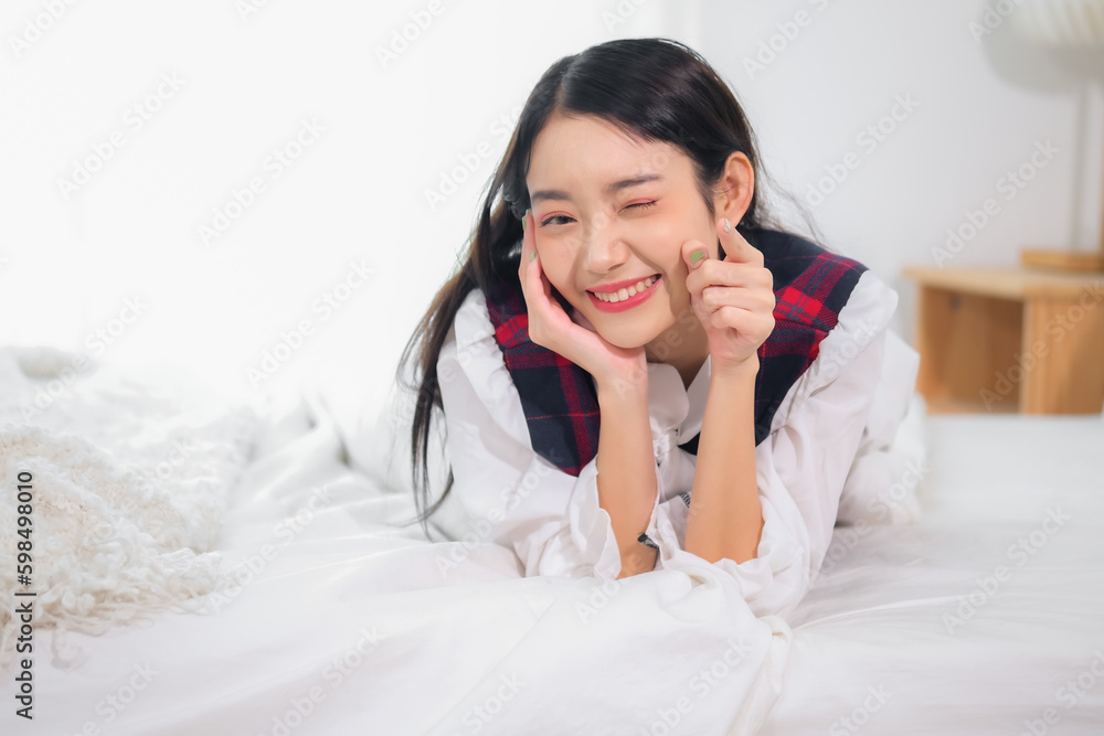 Beautiful asian woman eyes were closed and her lips were curled up into a mischievous smile in bedroom. Beautiful asian woman eyes were closed and her lips were curled up into a mischievous smile in bedroom.