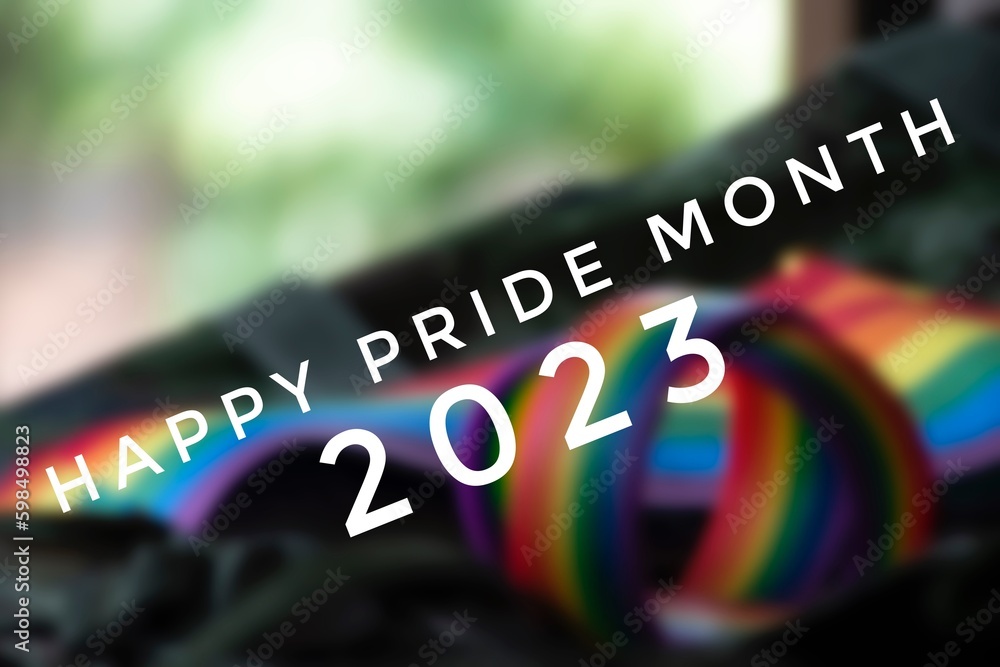 Happy Pride Month 2023 with blurred rainbow wristband and flag background, concept for LGBT community celebrations in pride month, June, around the world. - obrazy, fototapety, plakaty 