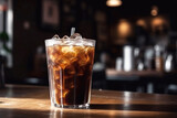 Glass of iced coffee on cafe background, created with Generative AI technology.