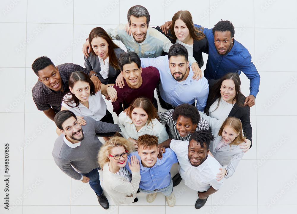 group of happy young people standing and looking up group of happy young people standing and looking up