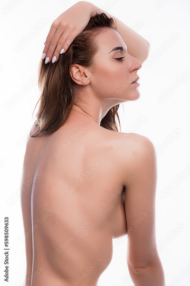 Close up portrait attractive young woman posing topless in studio, covering breast with hand true and natural beauty side view Close up portrait attractive young woman posing topless in studio, covering breast with hand true and natural beauty side view