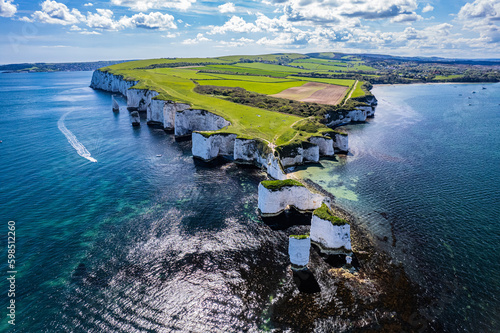 Leinwand Poster Aerial panoramic view of limestone cliffs and stacks with countryside at Old Harry Rocks in Dorset, UK