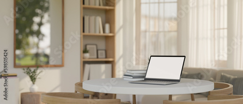 Fototapeta Naklejka Na Ścianę i Meble -  A laptop mockup on a white dining table in comfortable and minimal living room