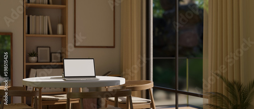 Close-up image of a laptop mockup on a minimal doing table in Scandinavian dining room