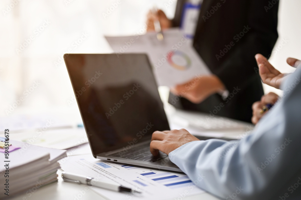 Close-up image of a businesswoman using her laptop during the meeting with her boss. Close-up image of a businesswoman using her laptop during the meeting with her boss.