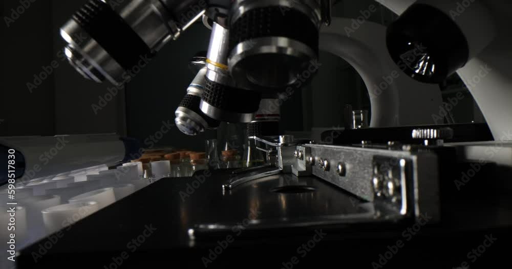 Modern microscopes and glass test tubes with corks. Laboratory