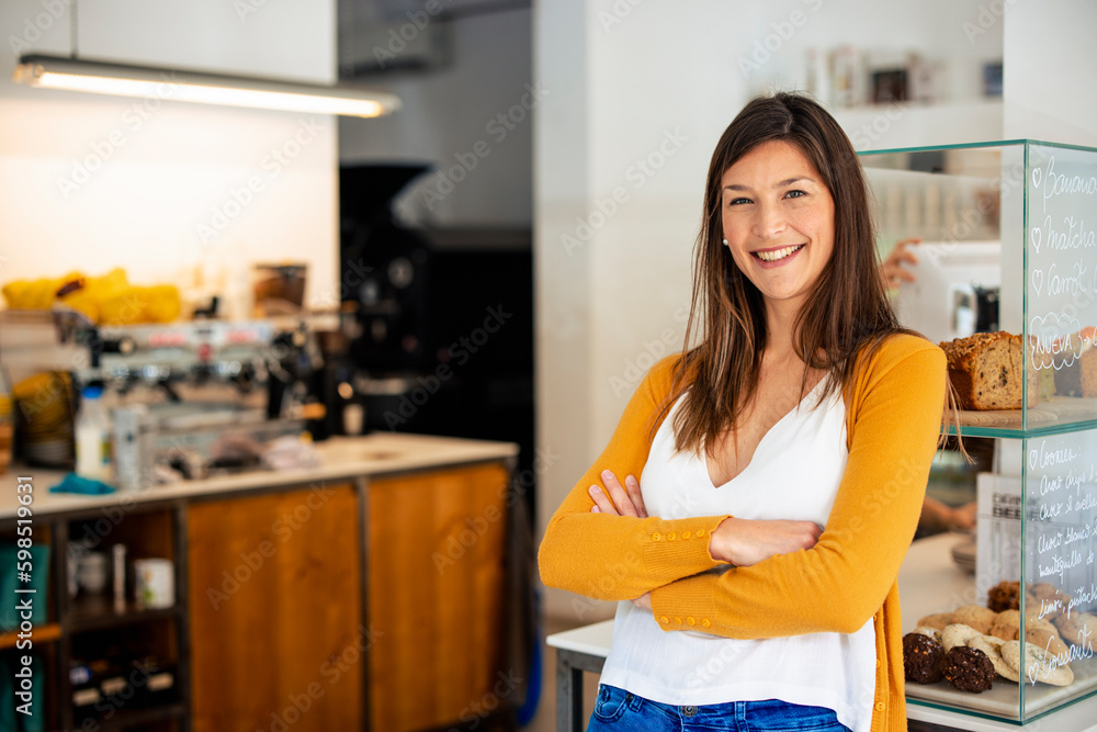 Happy owner with arms crossed at cafe Happy owner with arms crossed at cafe