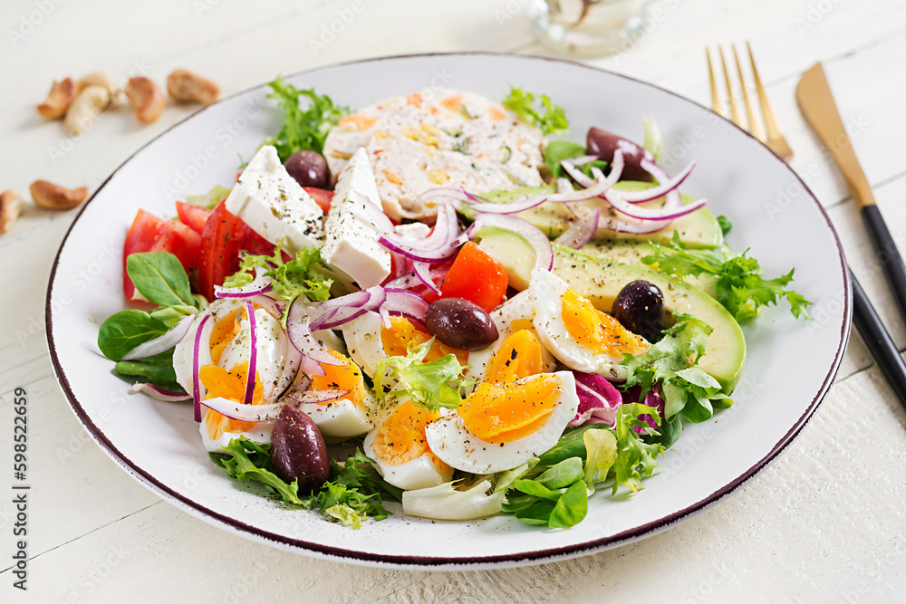 Chicken meatloaf and fresh vegetable salad of tomato, avocado, eggs, lettuce and feta cheese. Ketogenic, keto diet. Chicken meatloaf and fresh vegetable salad of tomato, avocado, eggs, lettuce and feta cheese. Ketogenic, keto diet.