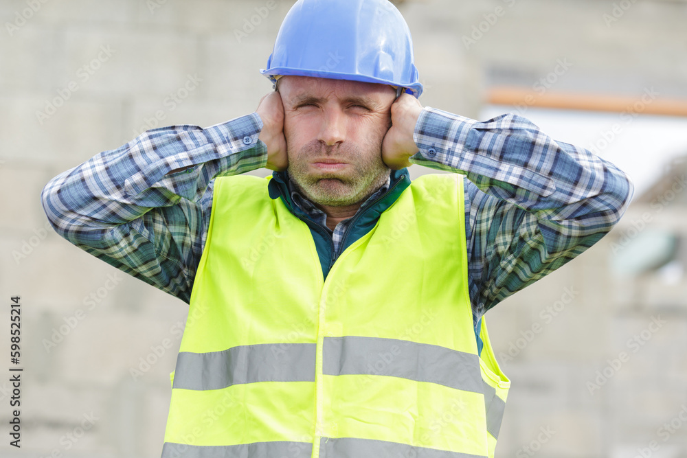 construction suffering from noise pollution on building site - obrazy, fototapety, plakaty 
