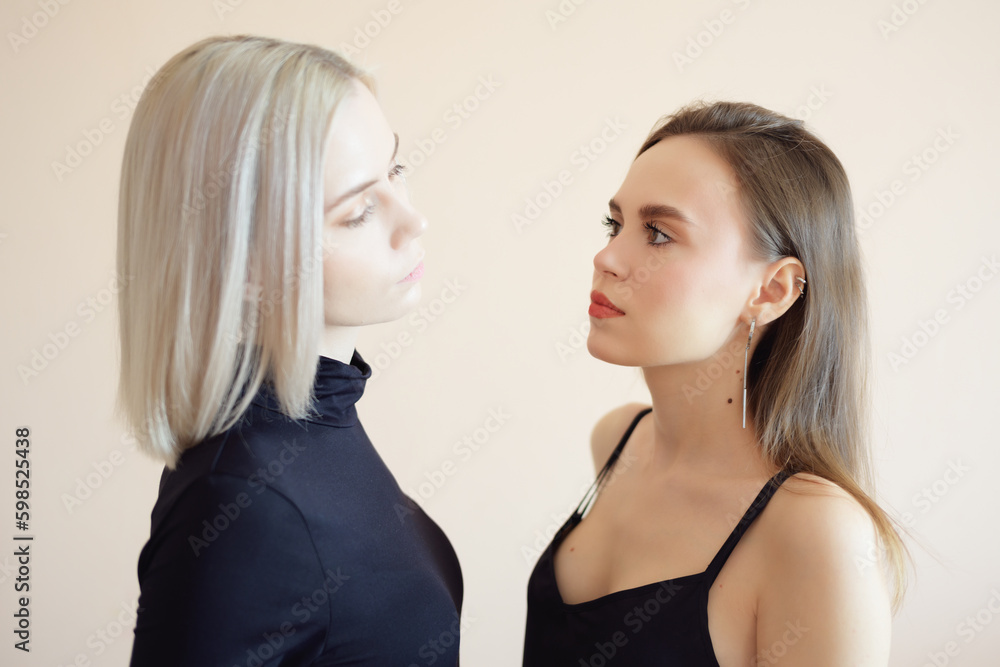 View of two young women on a light background. View of two young women on a light background.