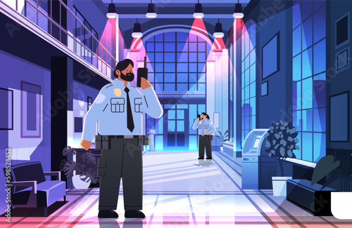 male security guard in uniform using walkie-talkie in night office public or private safety concept