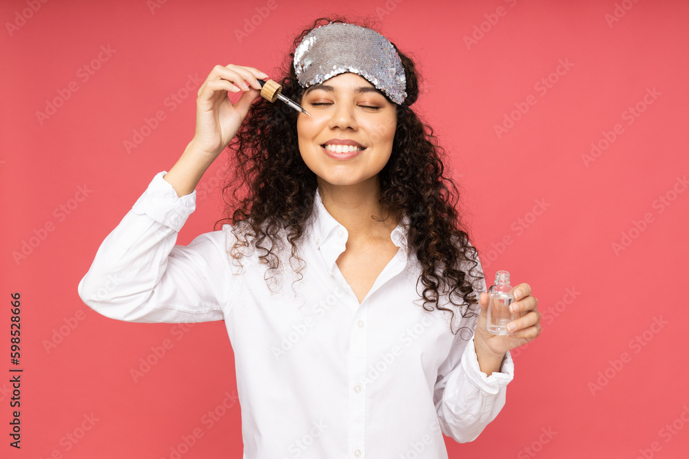 Young woman with sleep mask on pink background Young woman with sleep mask on pink background