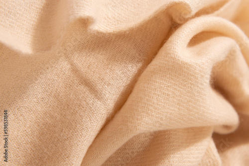 Natural wool creamy colored fabric. Cashmere, wool. Texture of natural wool fabric. Knitwear.