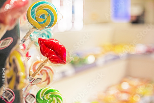 packaged lollipop in the form of red lips in the store on the counter