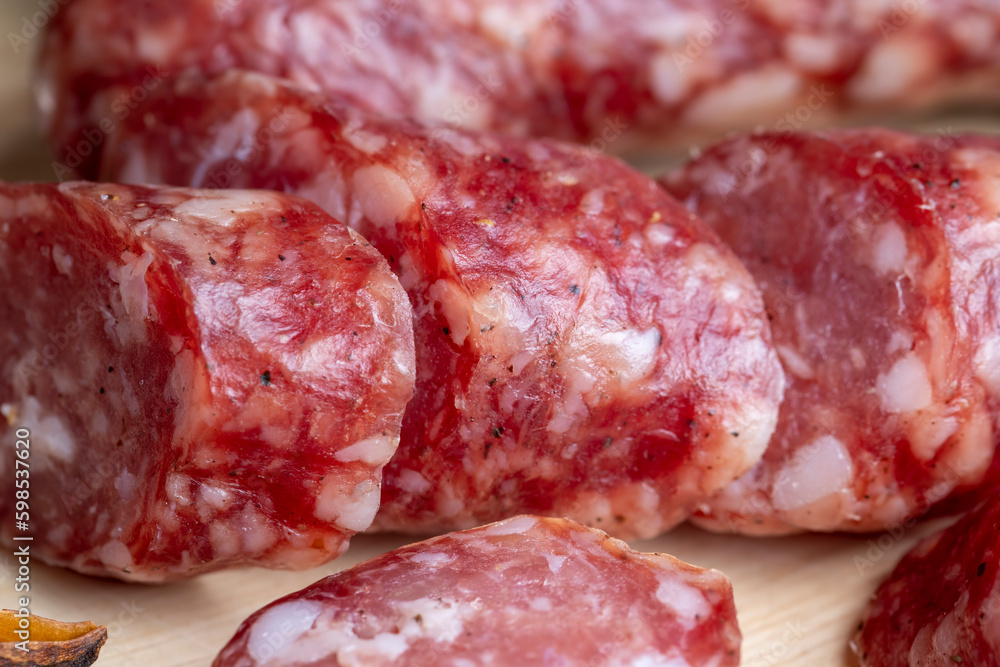 Dried veal sausage during slicing Dried veal sausage during slicing