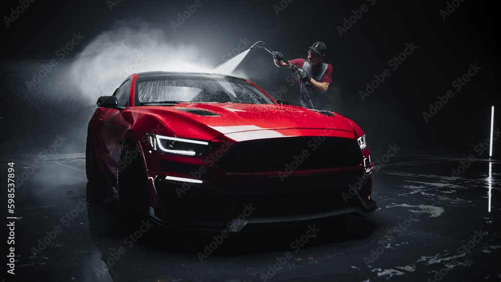 Adult Car Washer in Uniform Washing a Red Performance Car with a High
