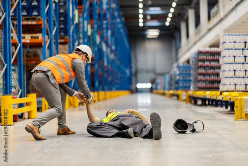 Injured warehouseman is lying on the ground and manager runs to help him. © dusanpetkovic1