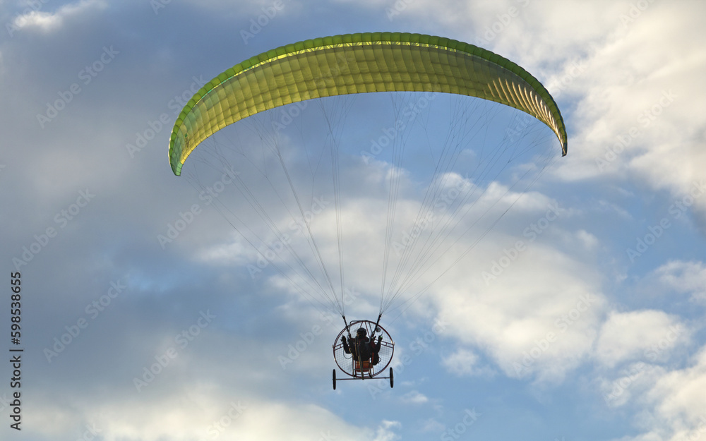 The motorized hang glider in the blue sky The motorized hang glider in the blue sky