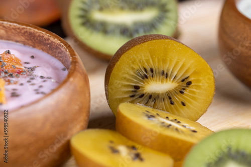 green and yellow kiwi fruit cut into pieces, close up