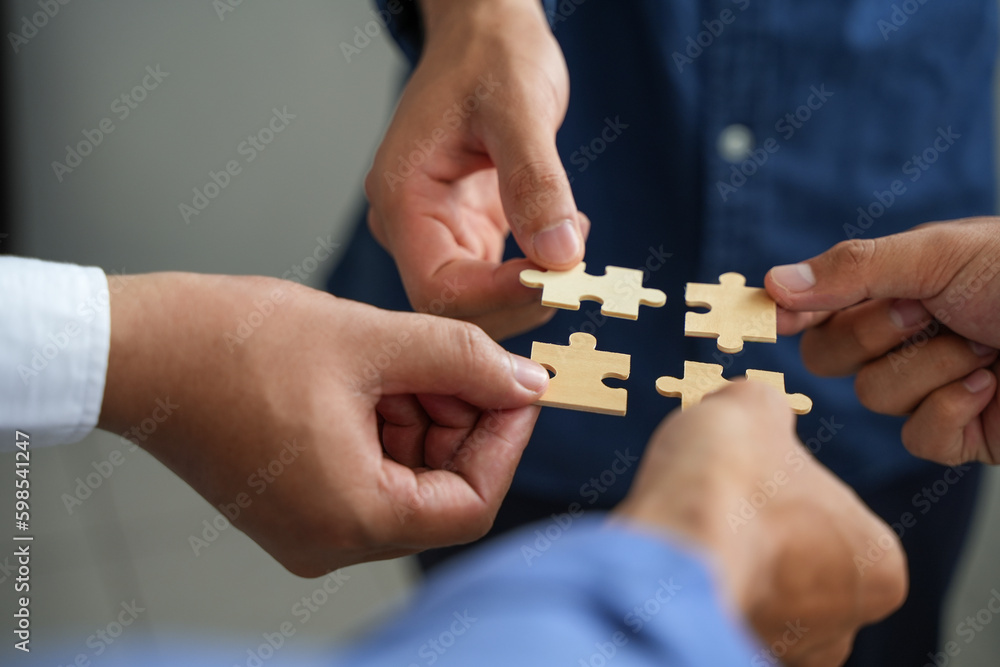 The concept of teamwork and partnership Hands joining puzzle pieces in office Businessmen put together a jigsaw puzzle - volunteer charity team business uniy. The concept of teamwork and partnership Hands joining puzzle pieces in office Businessmen put together a jigsaw puzzle - volunteer charity team business uniy.