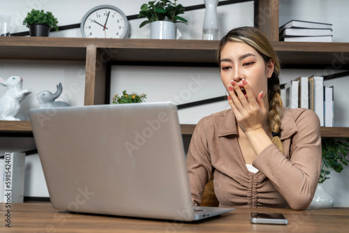 Young woman working on laptop computer at home © pixs4u