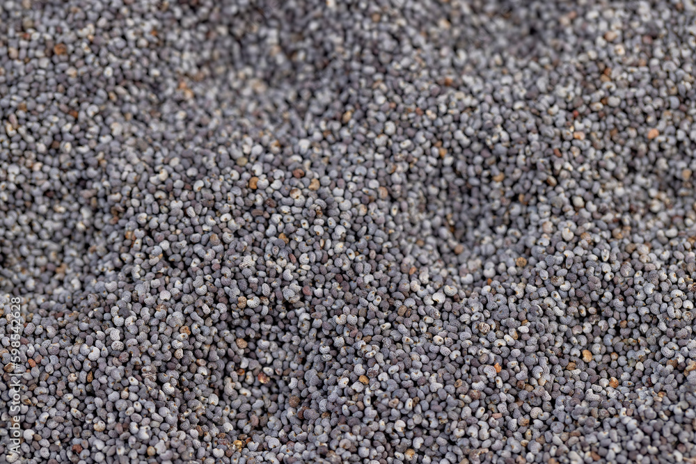 a close-up of a pile of poppy seeds used in cooking a close-up of a pile of poppy seeds used in cooking