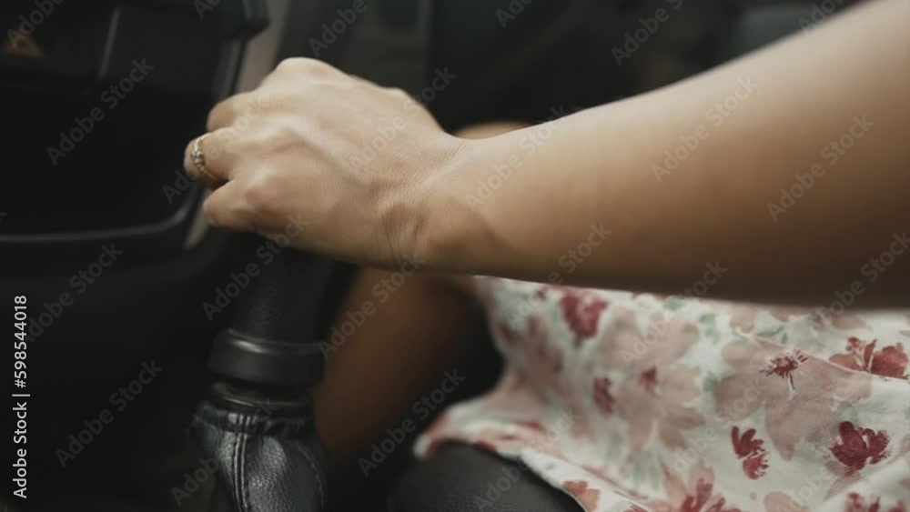 A modern girl's hand with a wedding ring on her finger. A married girl manually controls a manual transmission, shifts gears in a car. A close-up of a woman's hand. A modern girl's hand with a wedding ring on her finger. A married girl manually controls a manual transmission, shifts gears in a car. A close-up of a woman's hand.
