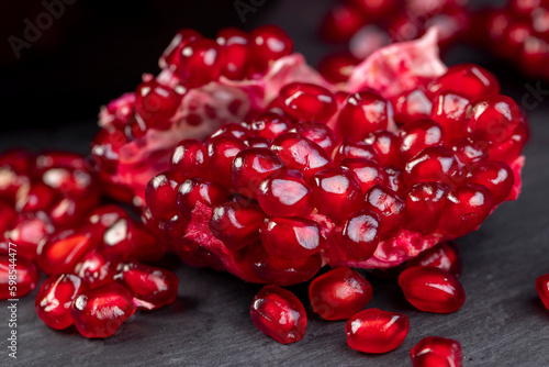 Grains of red ripe pomegranate close up
