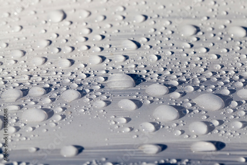 plastic surface of grass packaging covered with water droplets