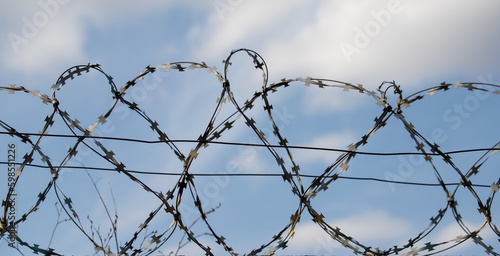 round barbed wire against the blue sky
