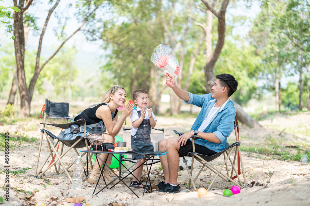Family enjoying a camping holiday in the countryside ,Camping, travel, tourism, hiking and people. Concept - Happy family with backpacks and thermos at camp. Family enjoying a camping holiday in the countryside ,Camping, travel, tourism, hiking and people. Concept - Happy family with backpacks and thermos at camp.