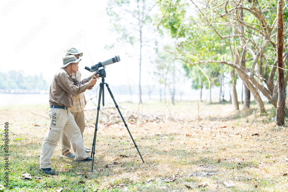 Bird watchers with tripod and spotting scope.