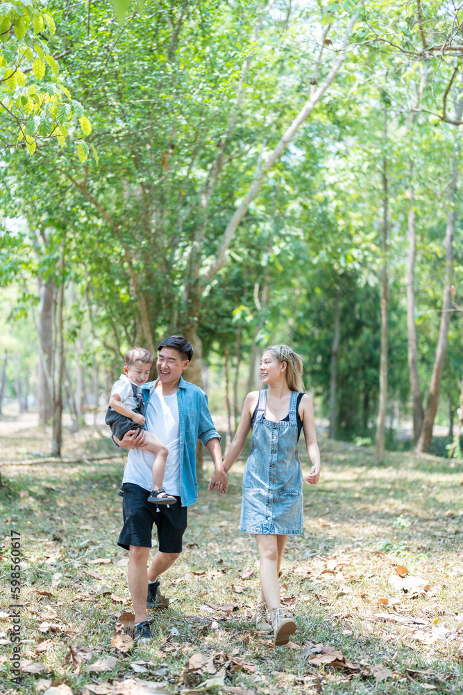 Family enjoying a camping holiday in the countryside ,Camping, travel, tourism, hiking and people. Concept - Happy family with backpacks and thermos at camp. Family enjoying a camping holiday in the countryside ,Camping, travel, tourism, hiking and people. Concept - Happy family with backpacks and thermos at camp.