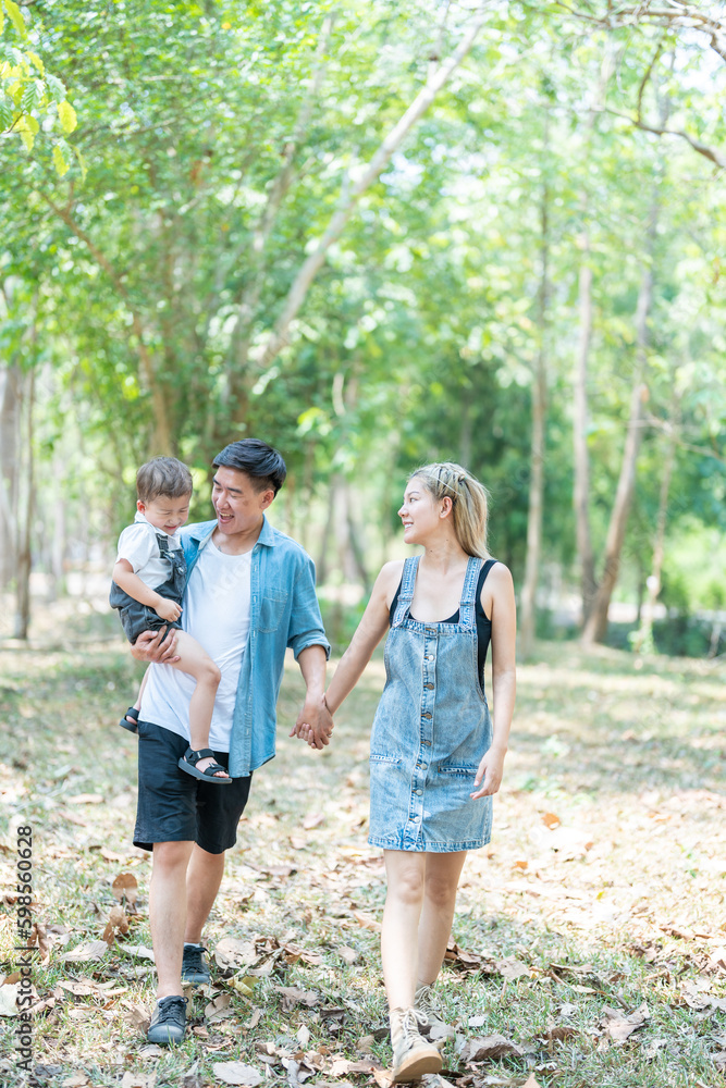 Family enjoying a camping holiday in the countryside ,Camping, travel, tourism, hiking and people. Concept - Happy family with backpacks and thermos at camp. Family enjoying a camping holiday in the countryside ,Camping, travel, tourism, hiking and people. Concept - Happy family with backpacks and thermos at camp.