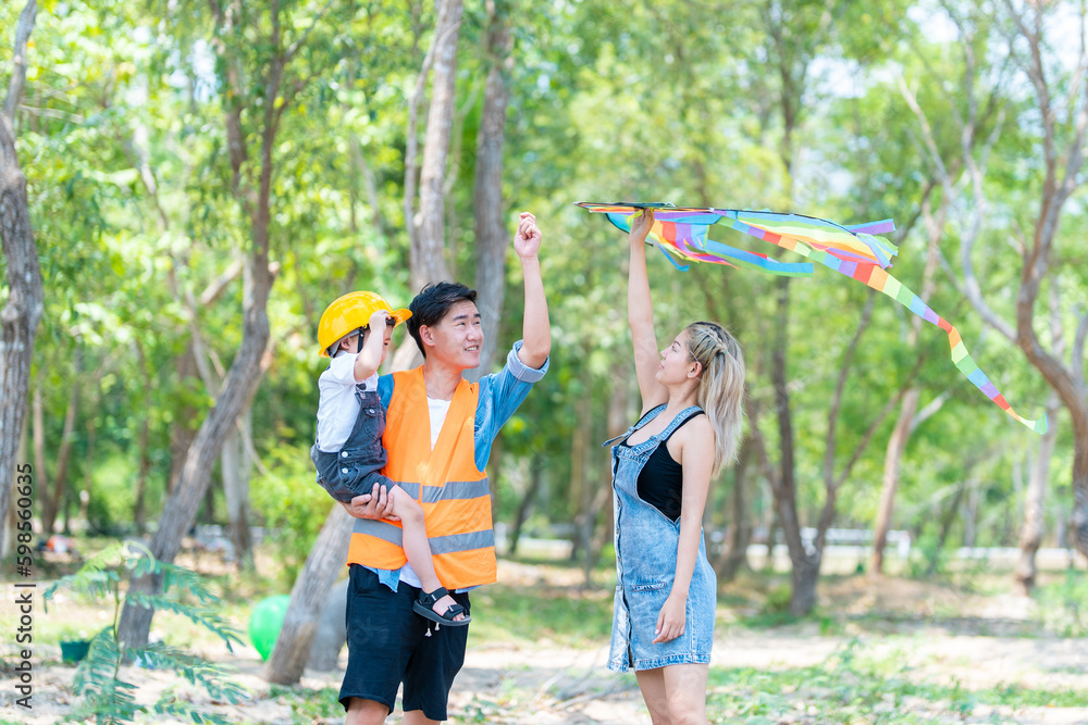 Obraz premium family happy in nature in summer parents and son fly a kite