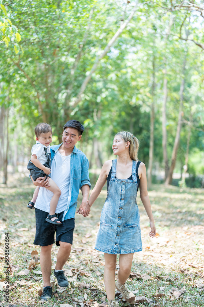 Family enjoying a camping holiday in the countryside ,Camping, travel, tourism, hiking and people. Concept - Happy family with backpacks and thermos at camp. Family enjoying a camping holiday in the countryside ,Camping, travel, tourism, hiking and people. Concept - Happy family with backpacks and thermos at camp.