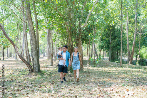 Family enjoying a camping holiday in the countryside ,Camping, travel, tourism, hiking and people. Concept - Happy family with backpacks and thermos at camp.