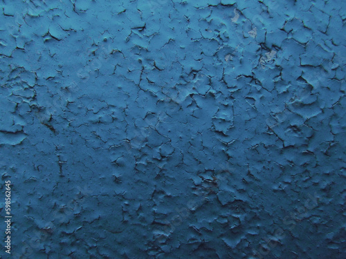 dark blue background painted metal swollen and cracked paint