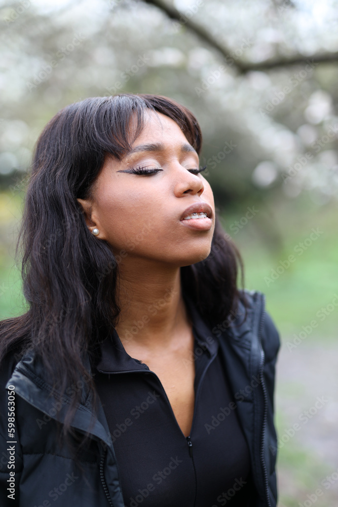Young african woman breathes fresh air in the park, portrait. Young african woman breathes fresh air in the park, portrait.